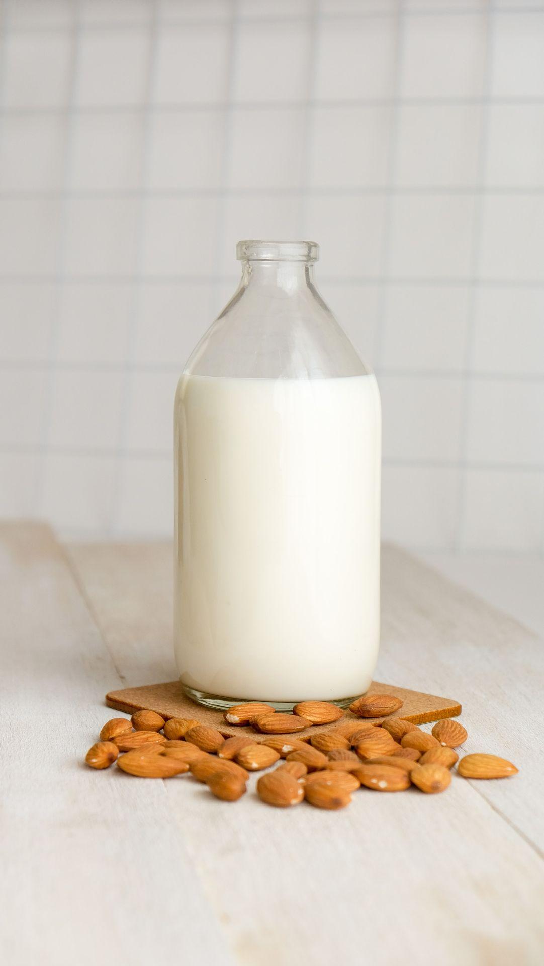 white milk in clear glass bottle