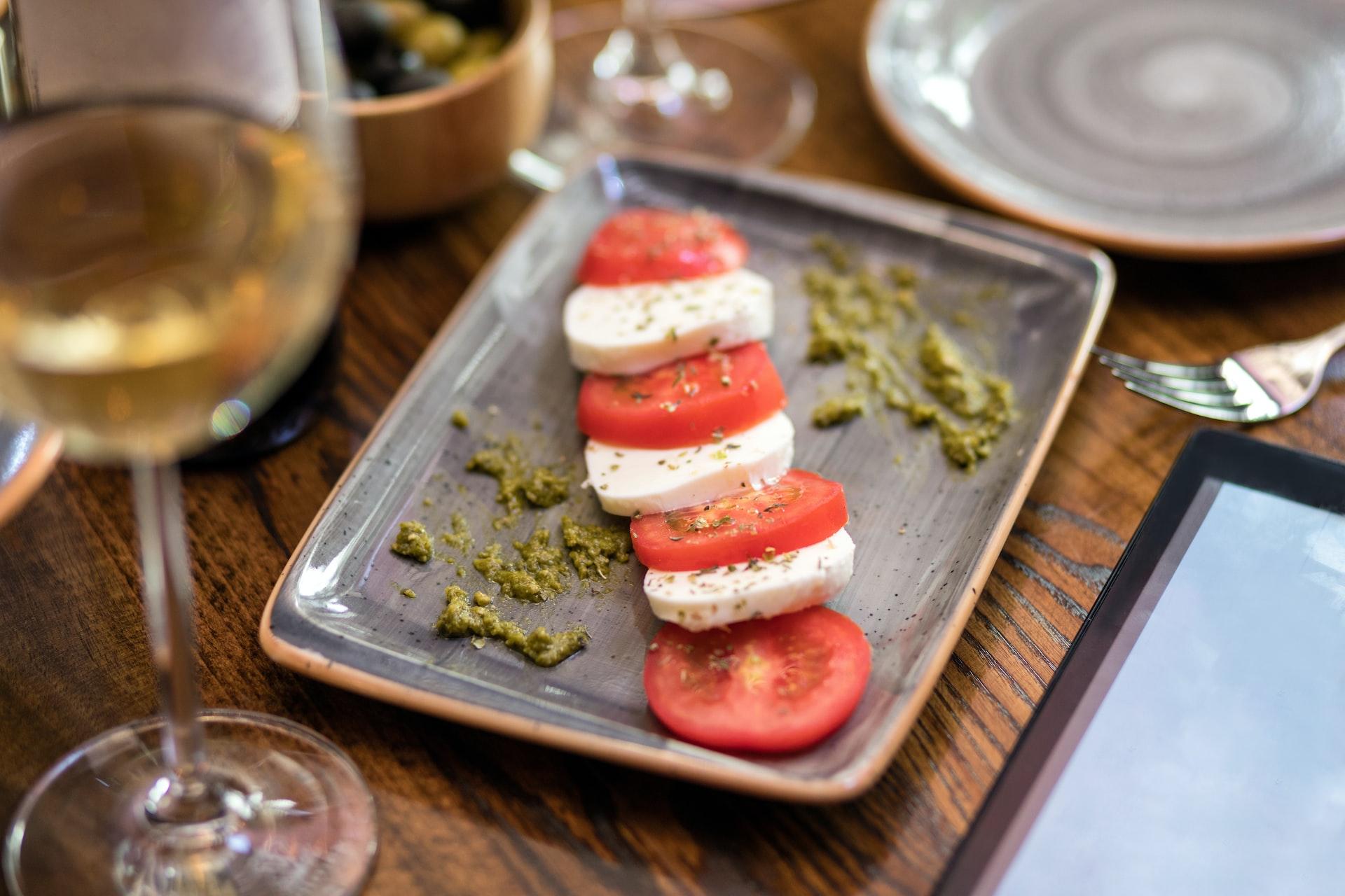 sliced tomato and green vegetable on stainless steel tray