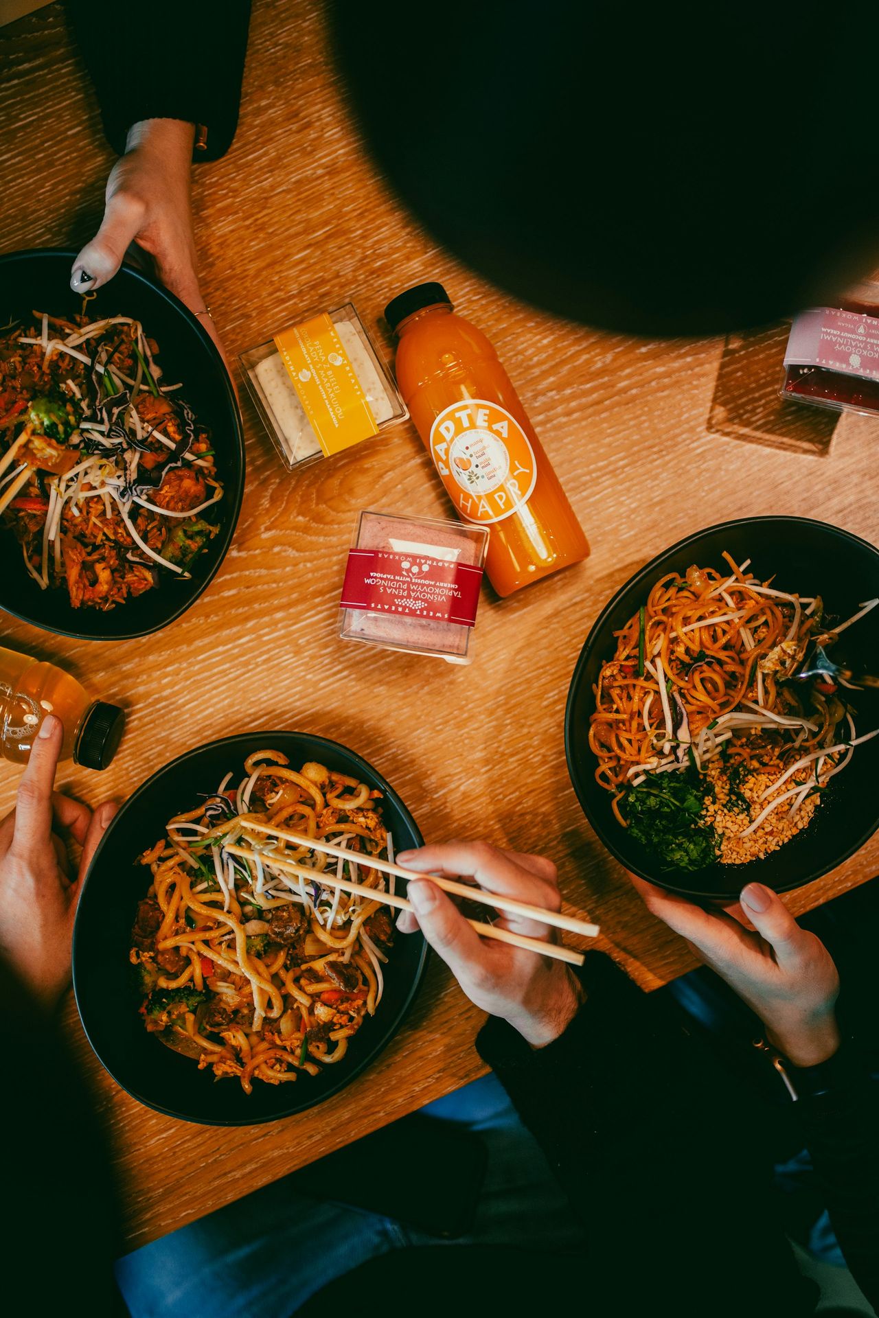 A table topped with plates of food and chopsticks